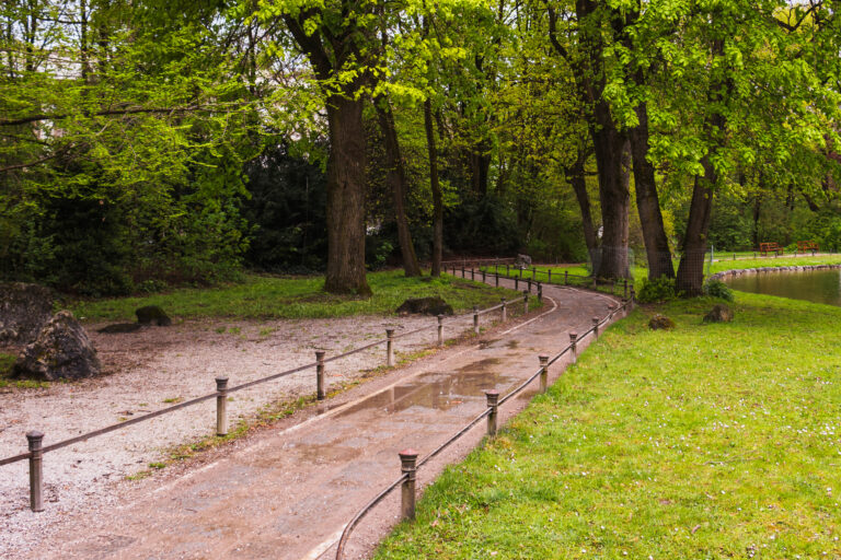 businesspeople standing outside office building with laptop